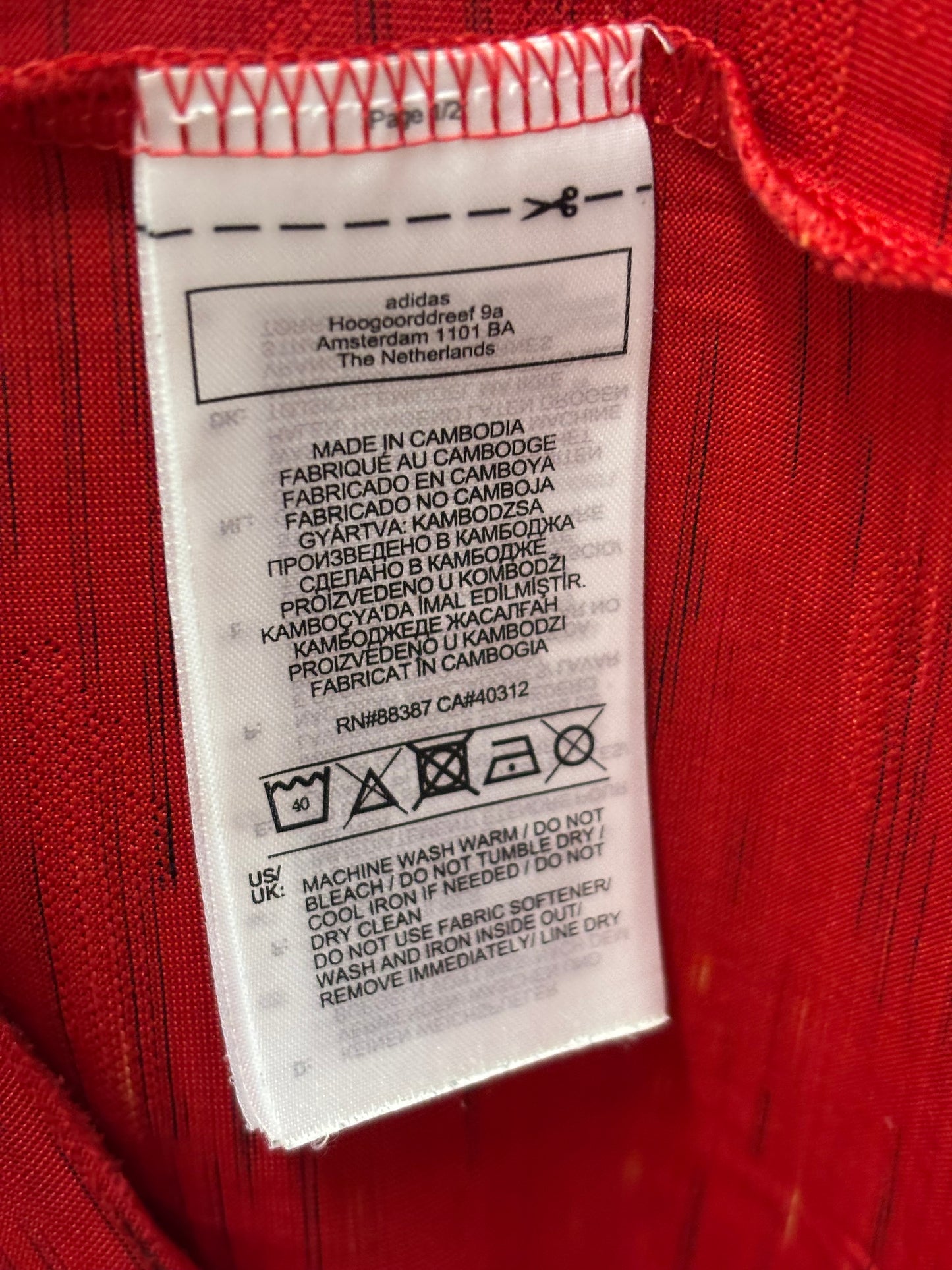 Manchester United 20/21 home shirt care label and sizing details for kids size 13-14/164