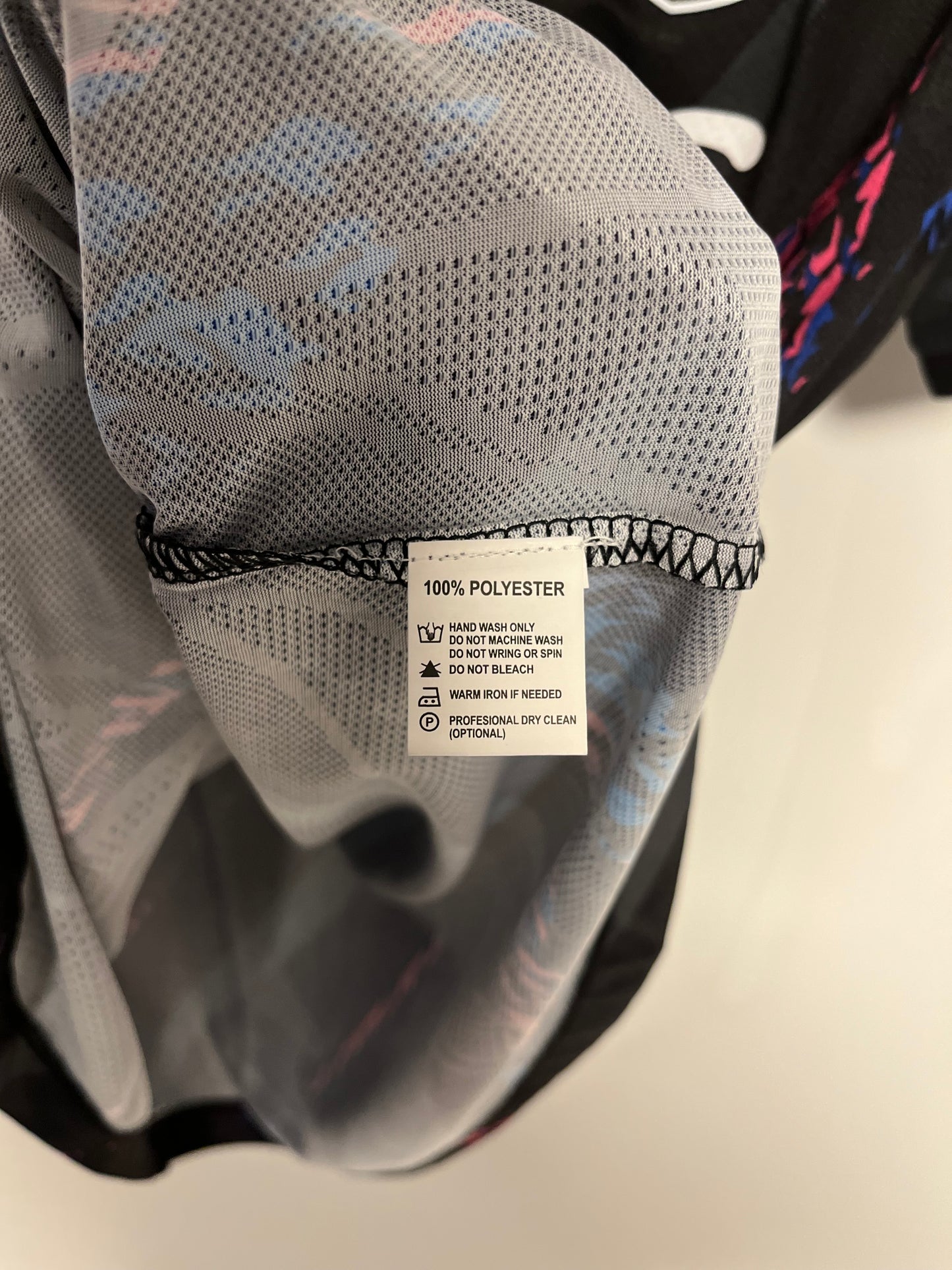 Gray textured fabric with a visible label on a neutral background