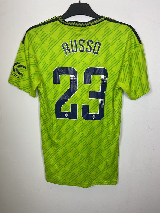 Green Adidas women's jersey with black text on a white background