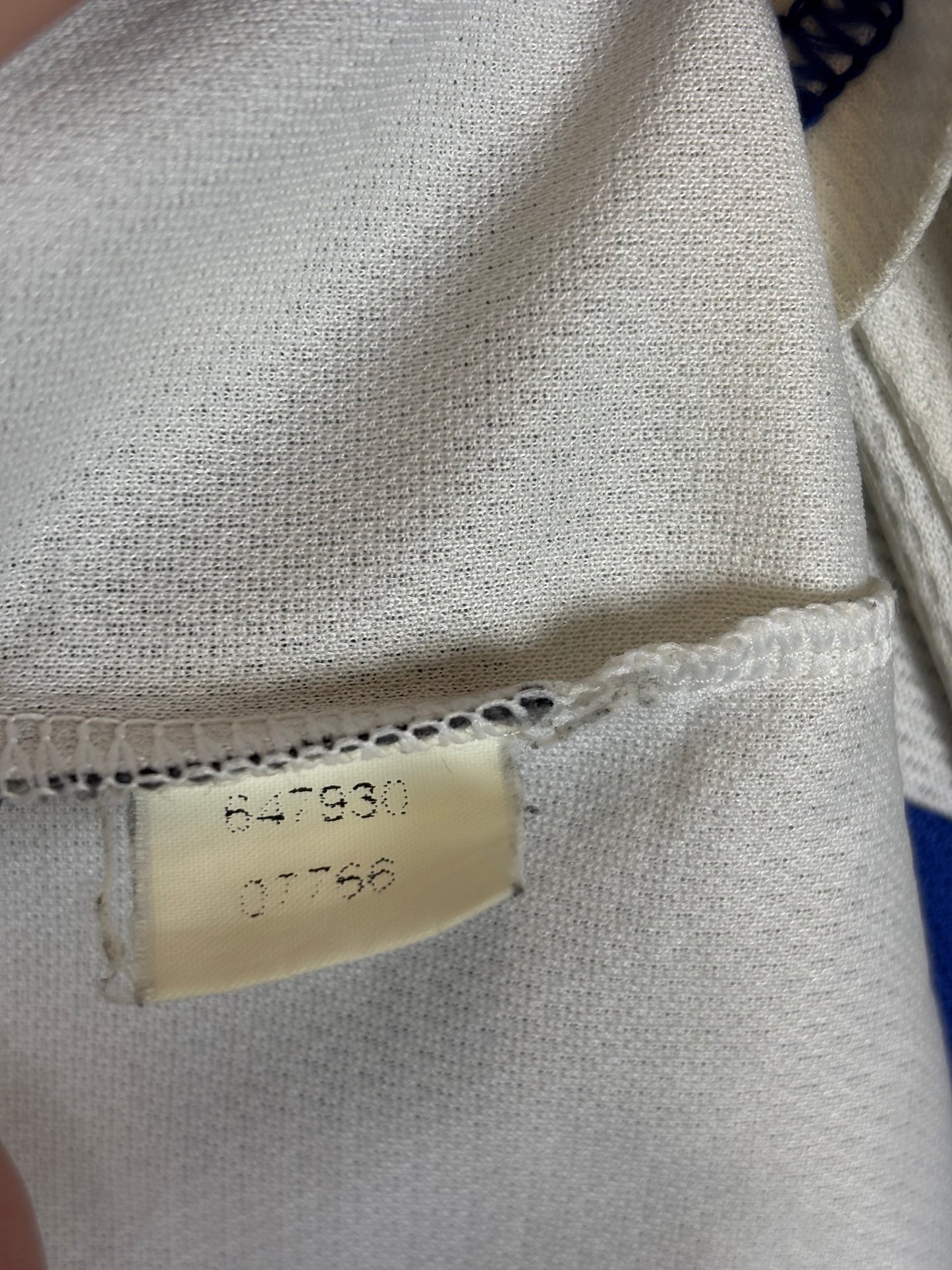 Close-up of a fabric texture with a visible label on a white background