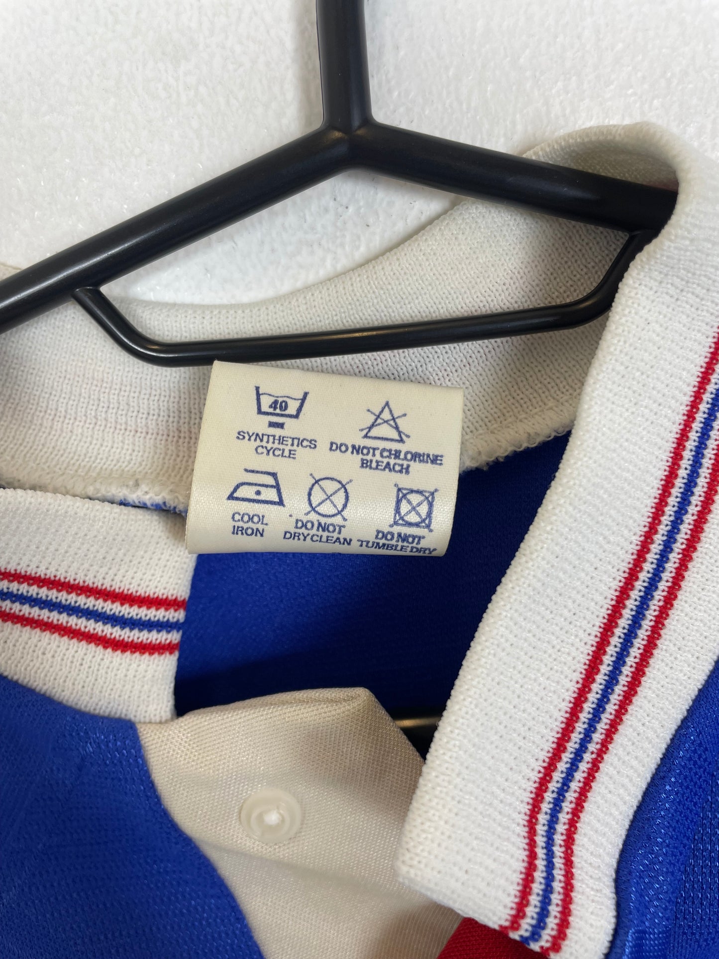 Close-up of the Macclesfield Town club crest on the 1989 FA Trophy winners kids shirt, detail shot from our store