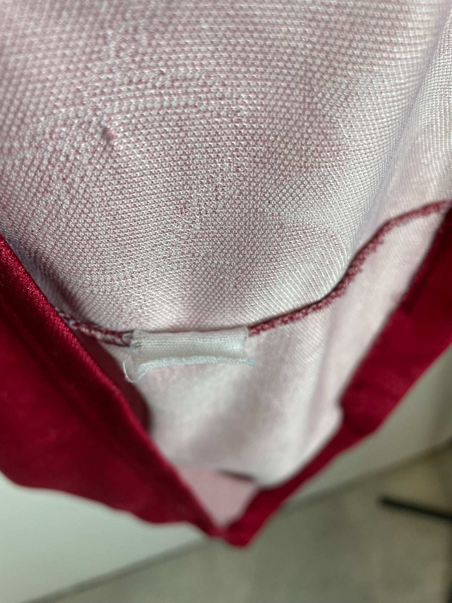 Close-up of a fabric edge with a visible seam and label.