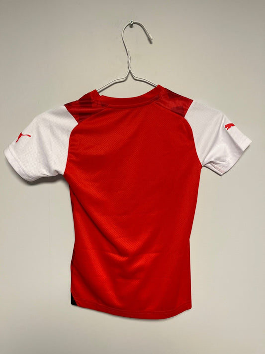 Front view of the Fleetwood Town 23/24 kids home shirt showing the Cod Army club badge, photographed at our Stavanger store