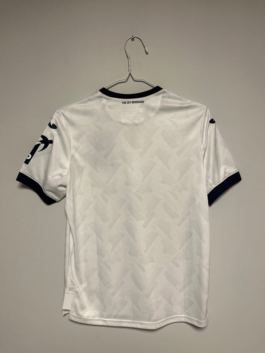 Front view of the Hoffenheim 20/21 kids home shirt showing the Bundesliga club badge, photographed at our Stavanger store