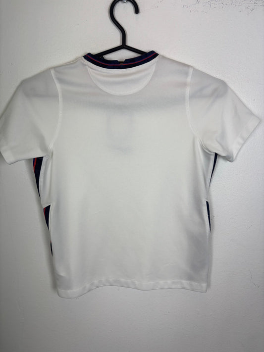 Front view of the England 2020 kids home shirt showing the national badge and Nike swoosh, shown in full front detail