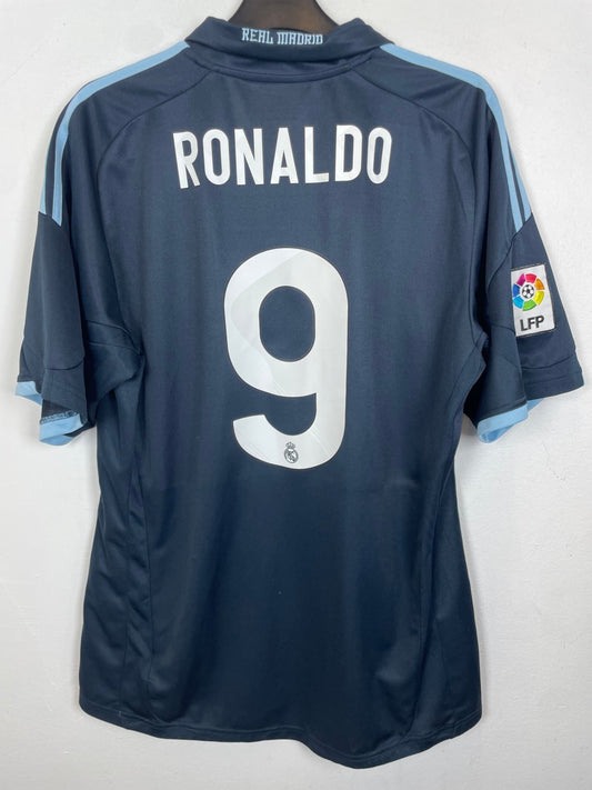 Front view of the Real Madrid 09/10 away shirt showing the club crest and Adidas branding, shown in full front detail
