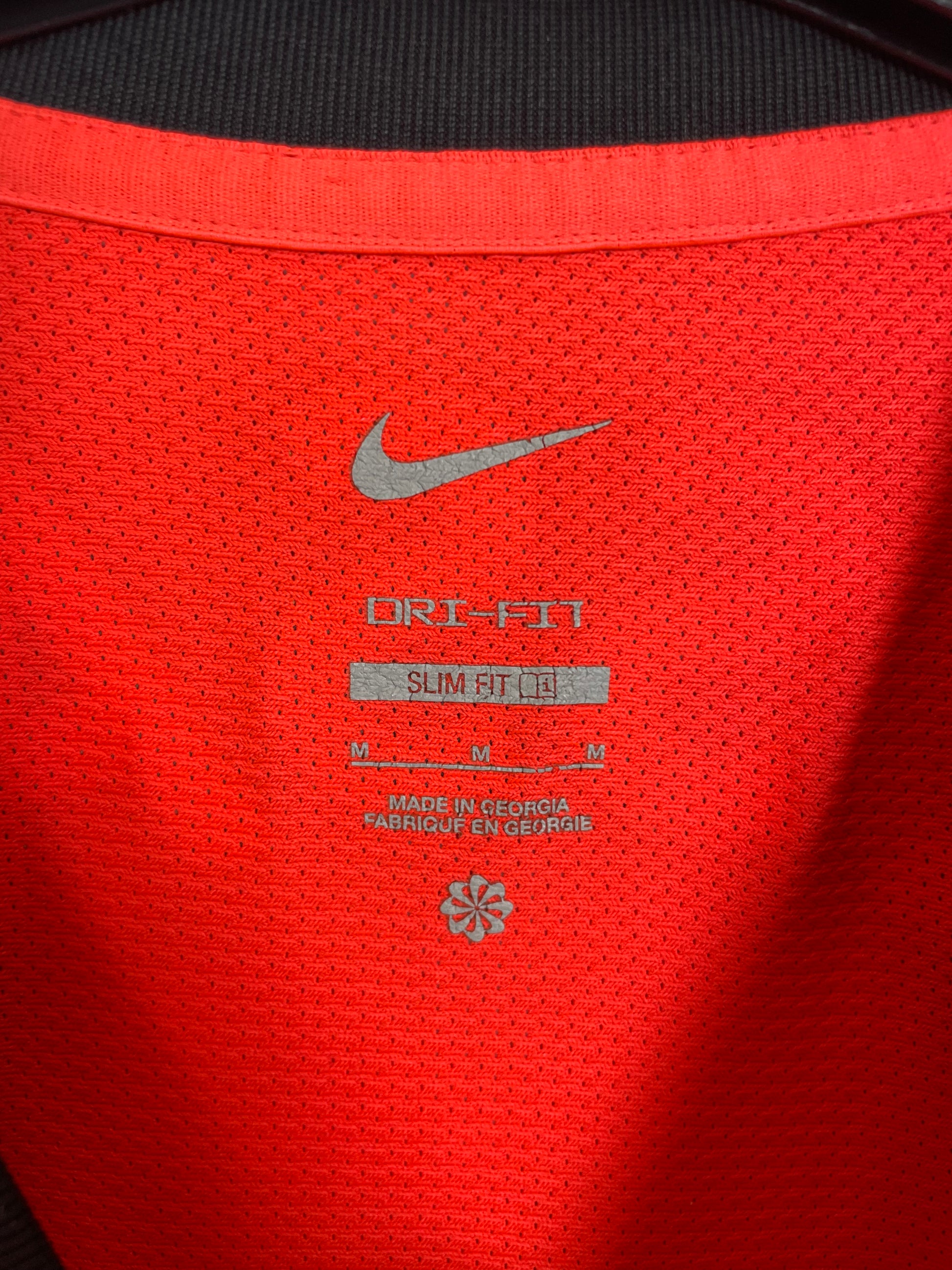 Close-up of Nike logo and Brighton club badge on white 22/23 away shirt with Trossard 11