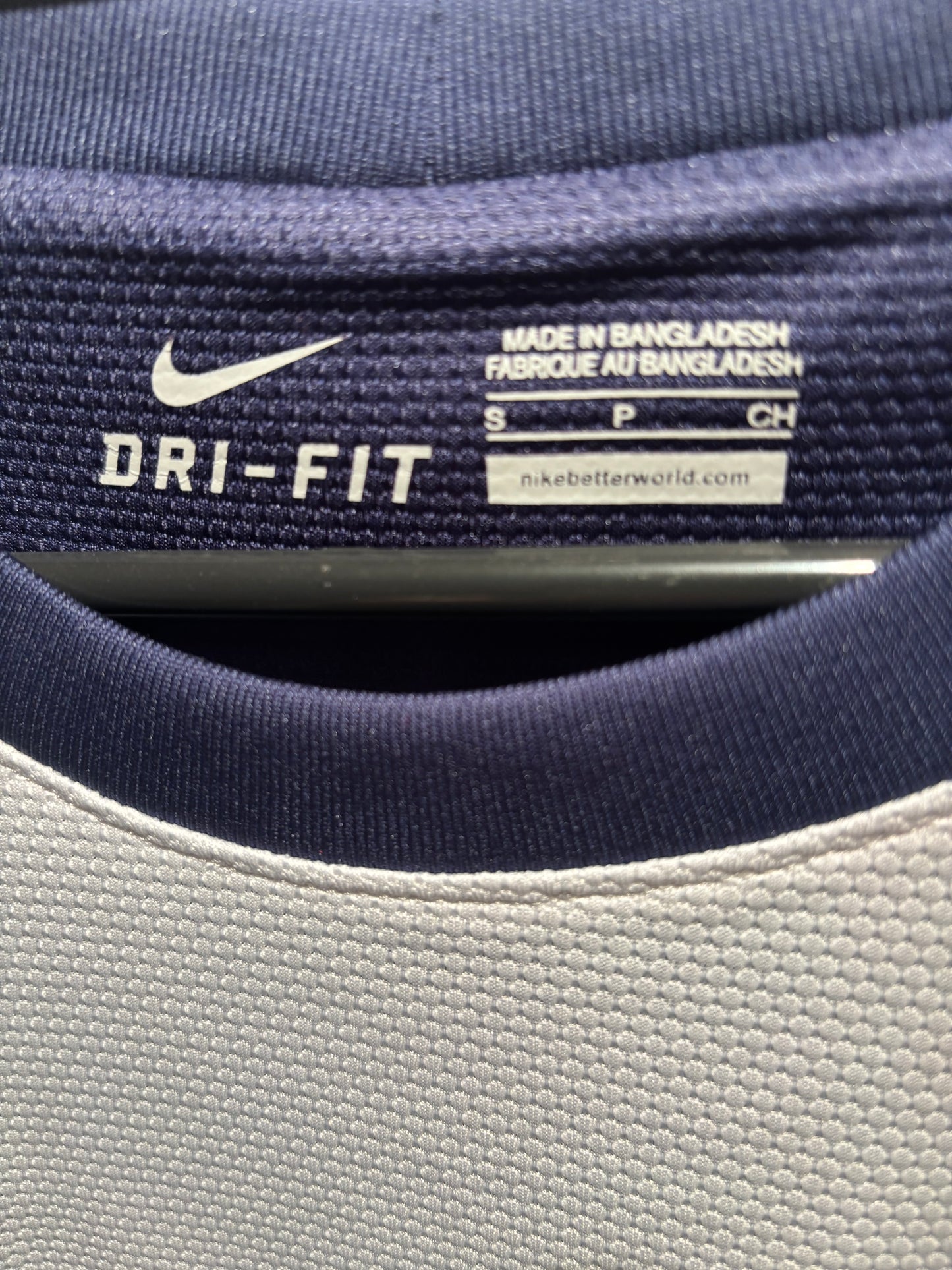 Close-up of a Nike Dri-FIT label on athletic clothing.