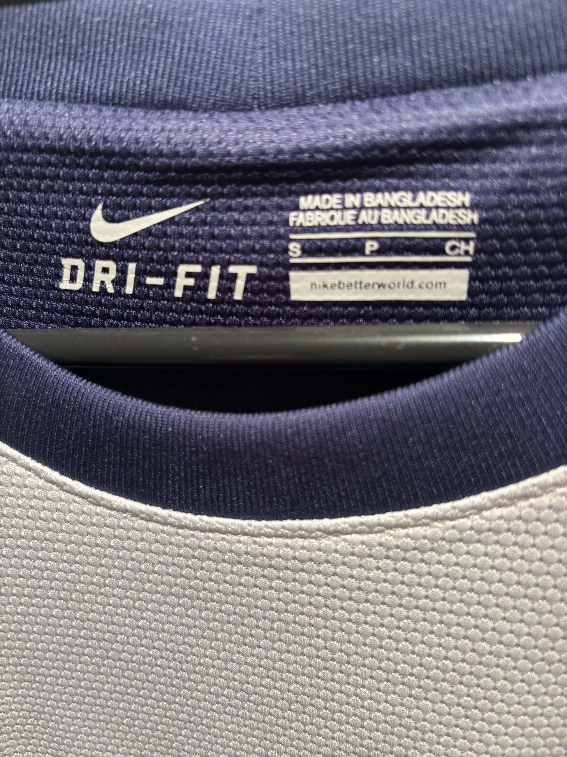 Close-up of a Nike Dri-FIT label on athletic clothing.