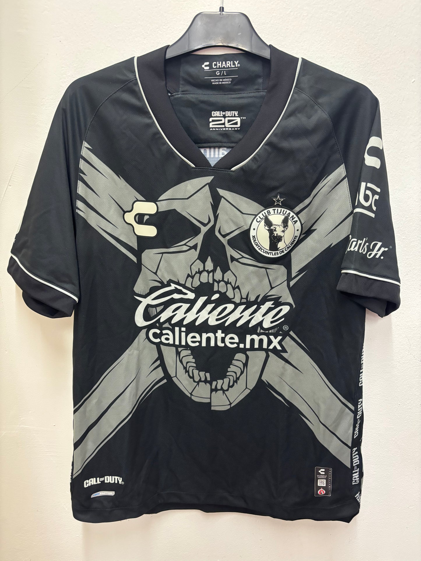 Black  Club Tijuana shirt  with branding and graphics on a light background