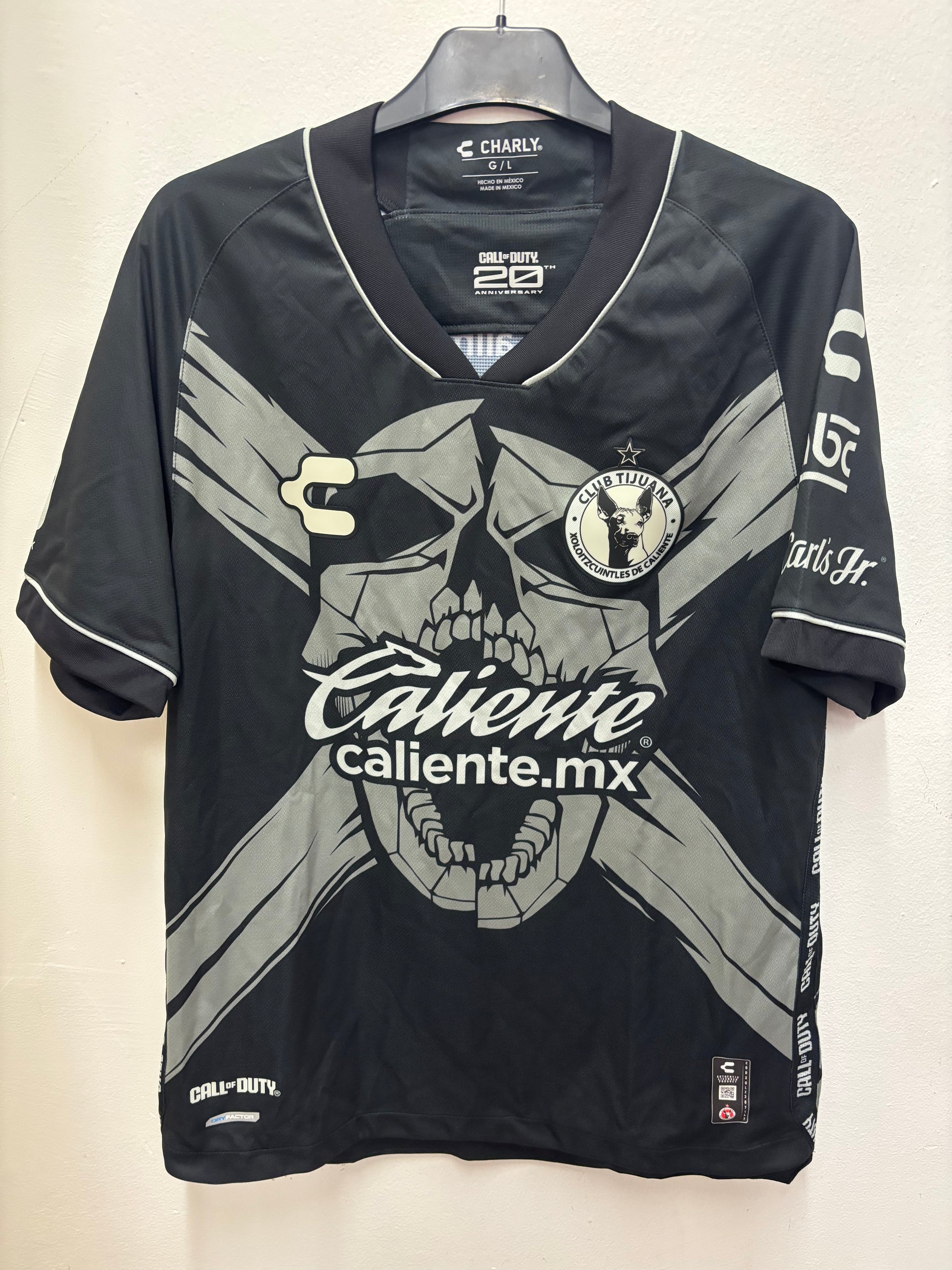 Black  Club Tijuana shirt  with branding and graphics on a light background