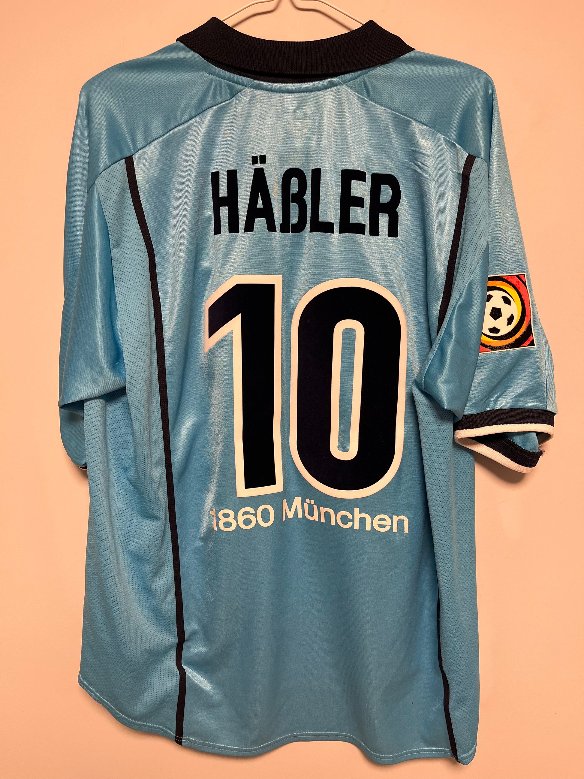 Blue football jersey with 'Häbler' and number '19' on a beige background