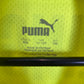Close-up of Puma logo and Borussia Dortmund club badge on 21/22 third kit jersey