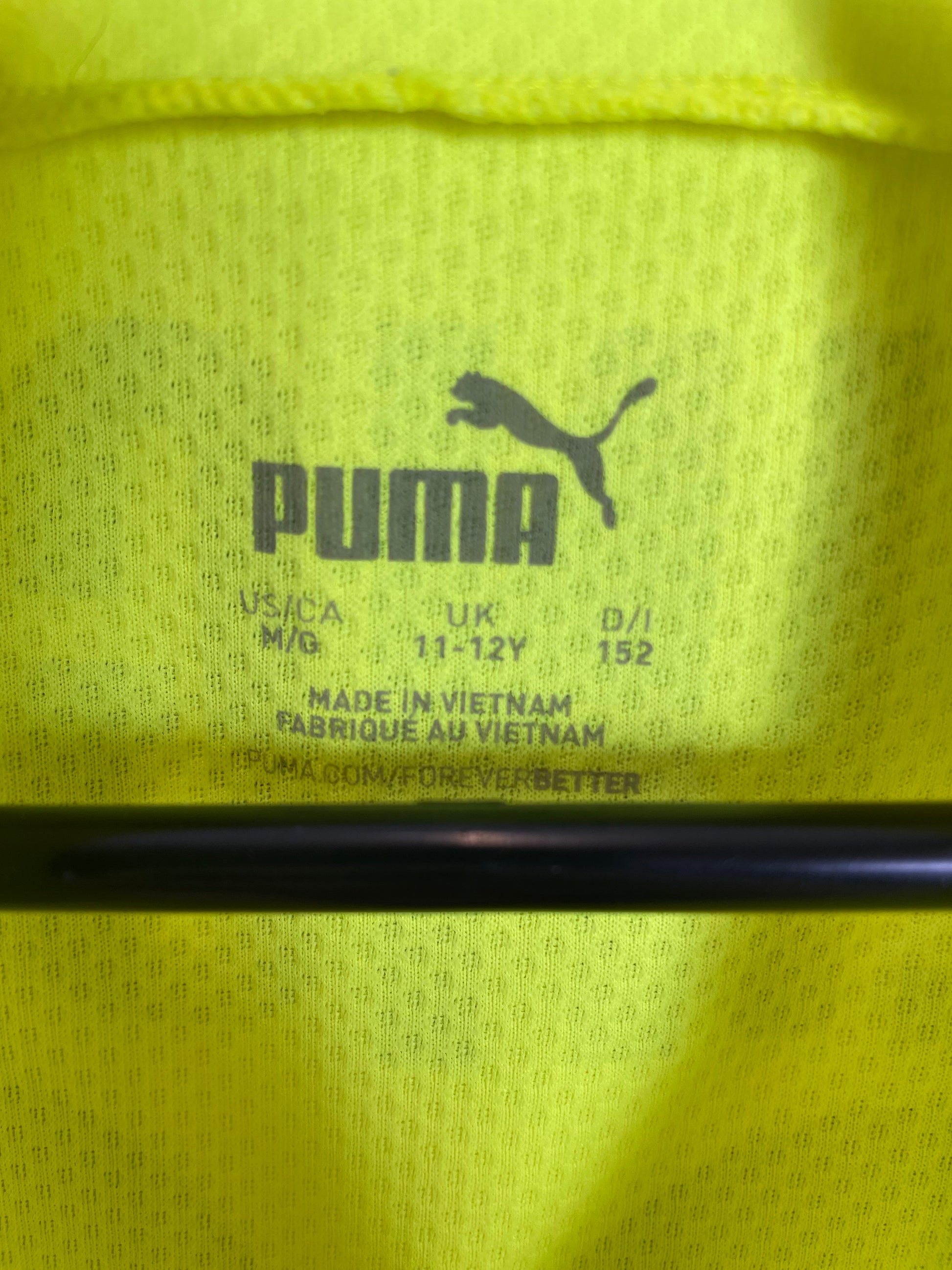 Close-up of Puma logo and Borussia Dortmund club badge on 21/22 third kit jersey