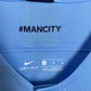 Manchester City 18/19 home — Nike Swoosh and Manchester City crest close-up