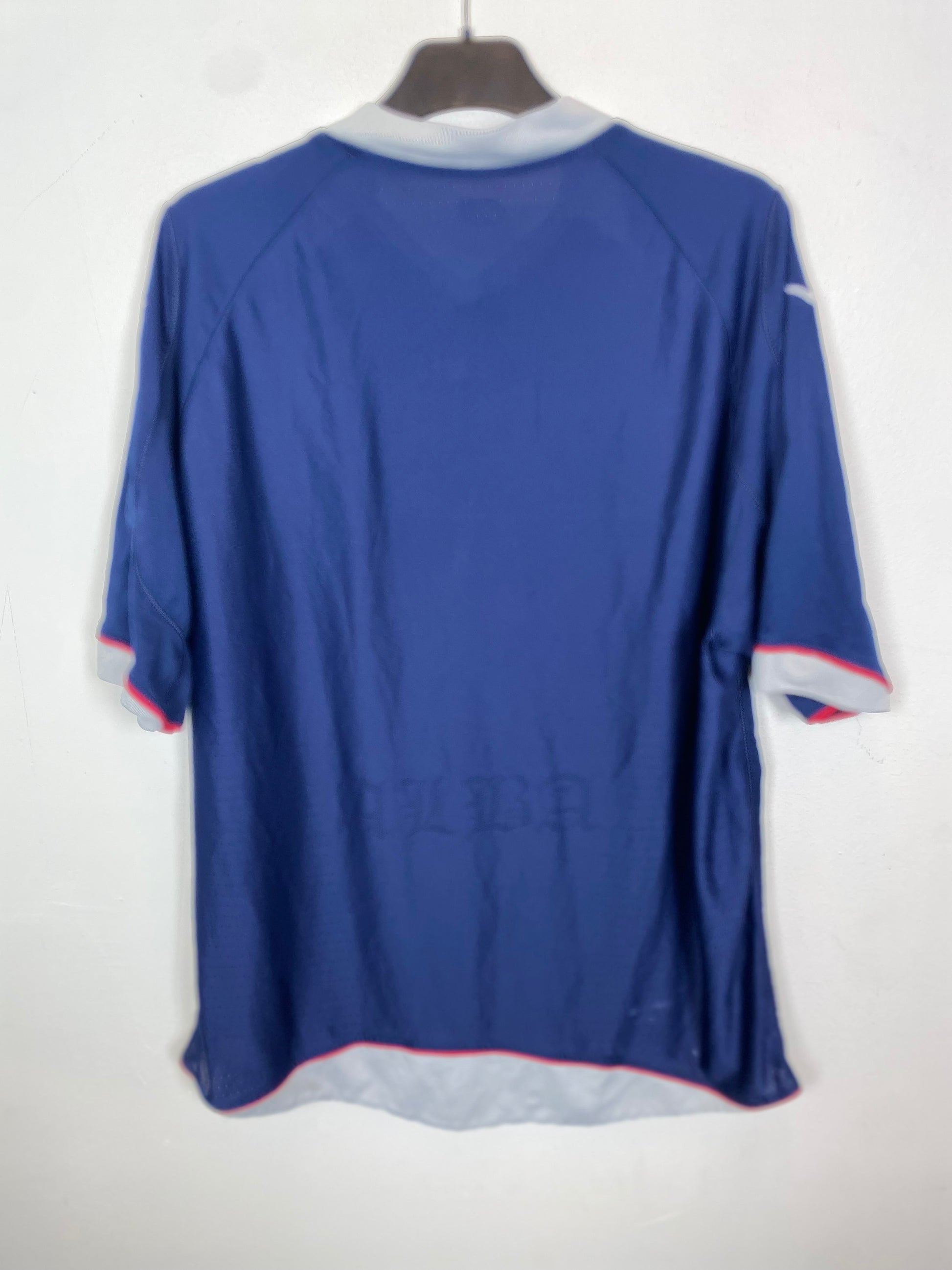 Blue Diadora Scotland Home 2008/09 jersey on a hanger against a white background