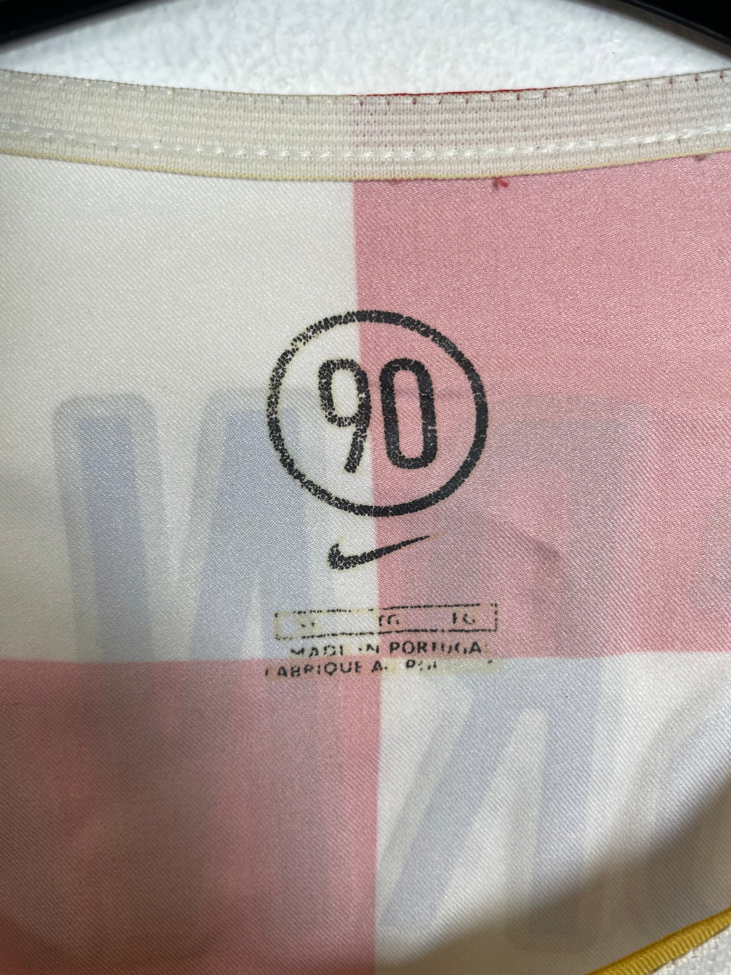Close-up of a fabric with a number '90' and text on it.