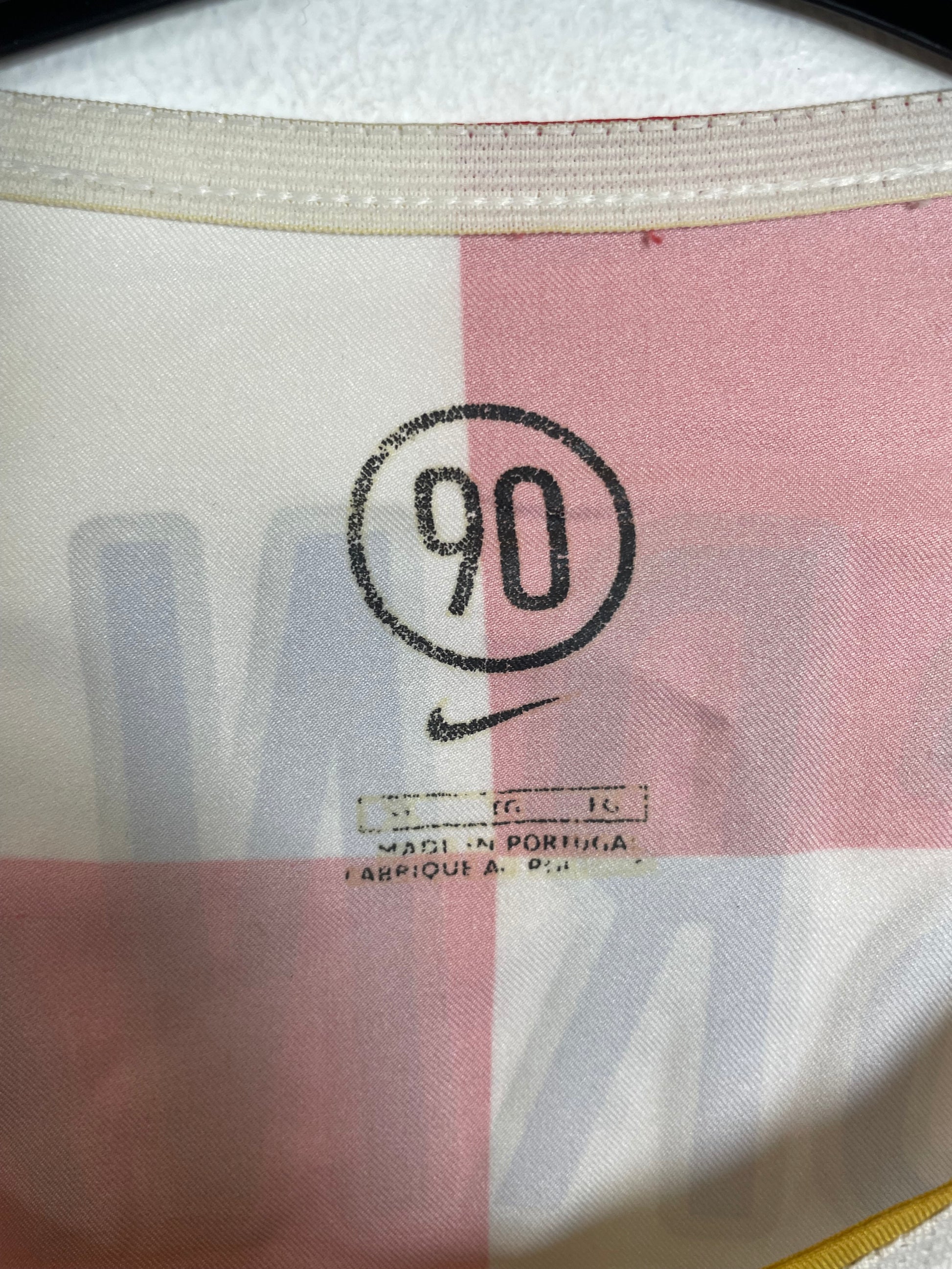 Close-up of a fabric with a number '90' and text on it.