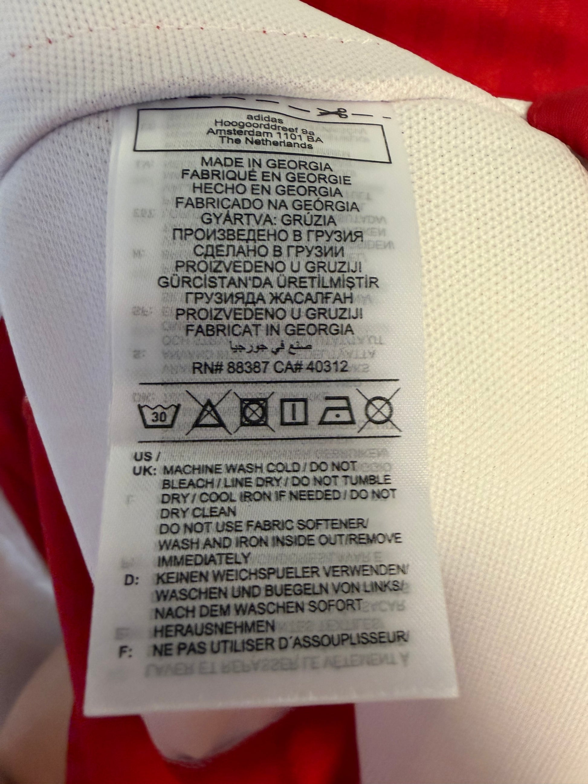 Interior care label and size XXL tag detail of authentic Adidas Ajax Henderson 6 home jersey
