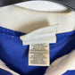 Close-up of a label on a blue and white garment with a blurred background