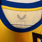 Close-up of a yellow and blue cap with a brand logo on the brim.