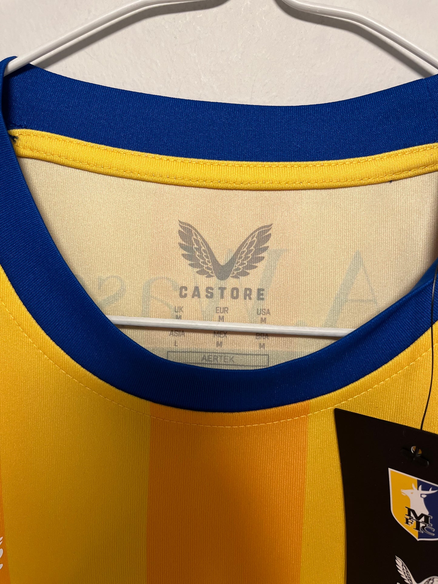 Close-up of a yellow and blue cap with a brand logo on the brim.