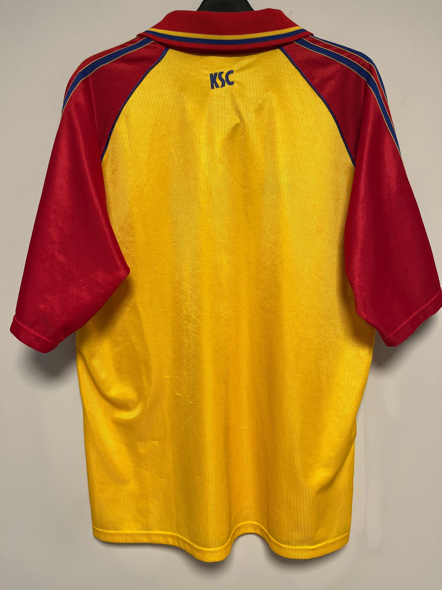 Yellow and red karlsruher shirt on a beige background