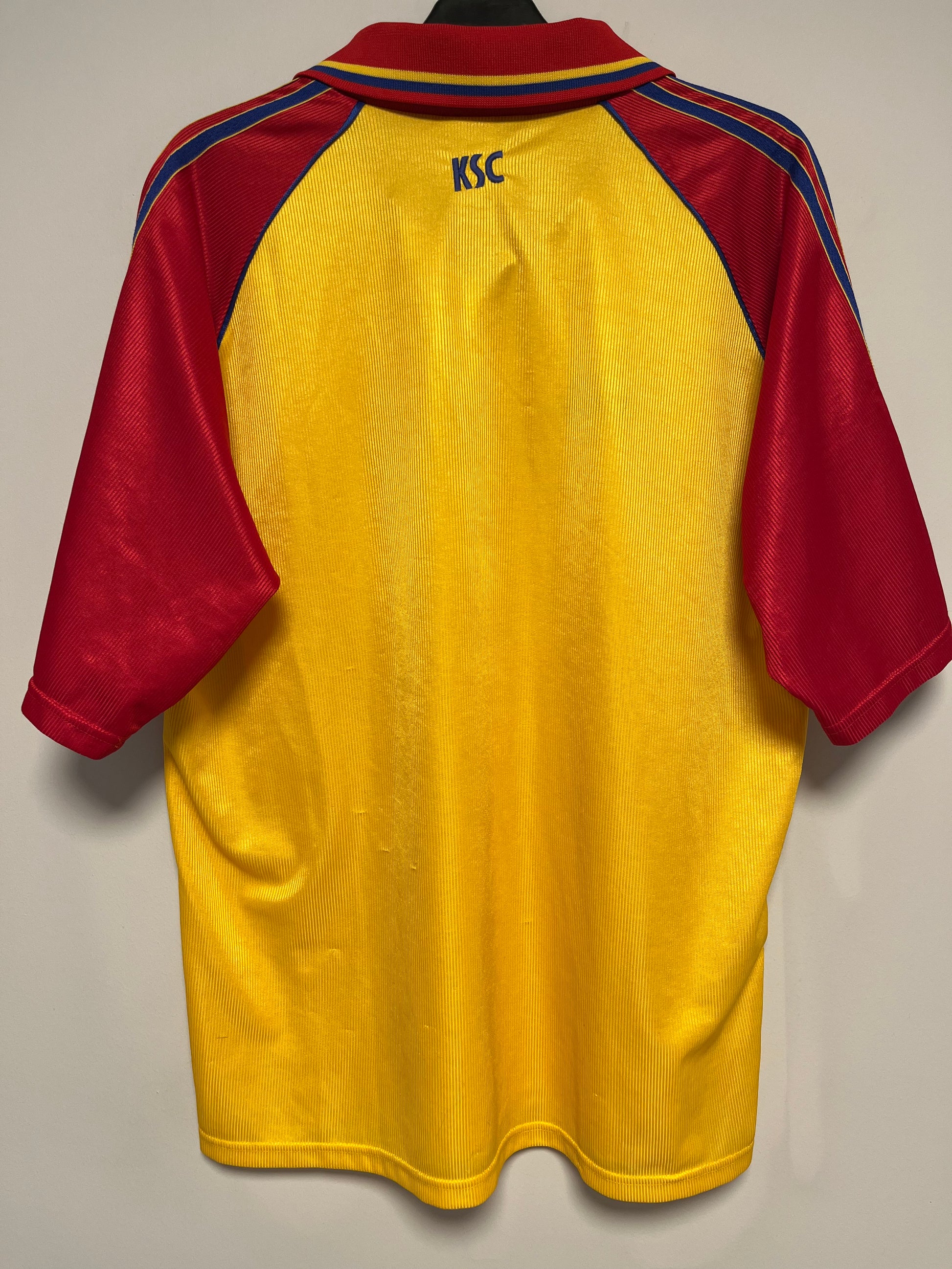 Yellow and red karlsruher shirt on a beige background