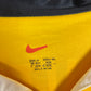 Close-up of Nike logo and Borussia Dortmund club badge on vintage 98/00 yellow home shirt