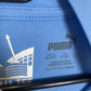 Close-up of Manchester City club badge and sponsor logo on sky blue 2023/24 home shirt