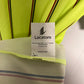 Close-up of a Lacoste label on a striped garment with a neutral background