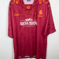Maroon as roma shirtwith orange accents and brand logos on a white background
