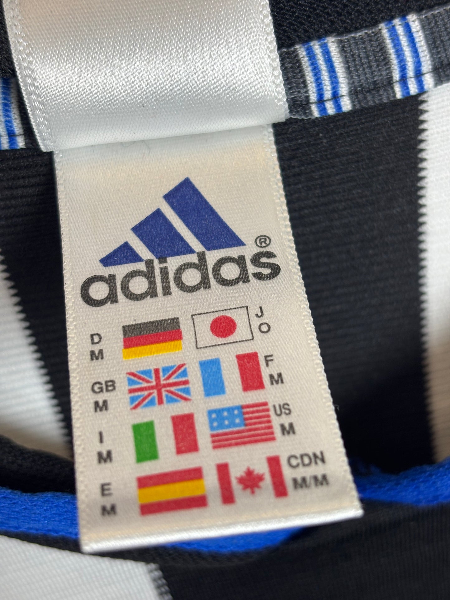 Newcastle United 2000/01 home shirt sponsor and Adidas logo detail with vintage finish
