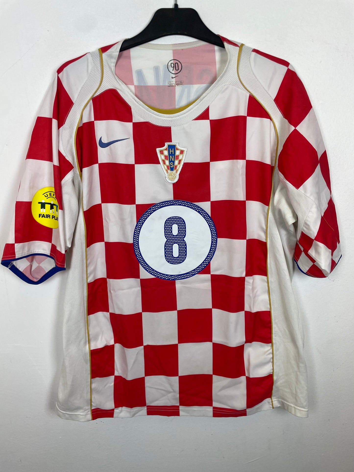 Red and white crosia football jersey with number 8 on a hanger against a white background