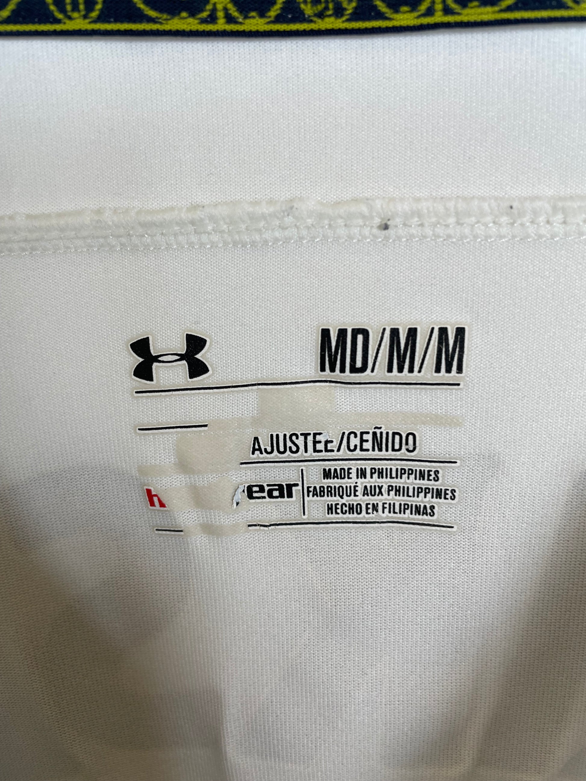 Close-up of Under Armour logo and Tottenham Hotspur cockerel badge on white 2014/15 home shirt