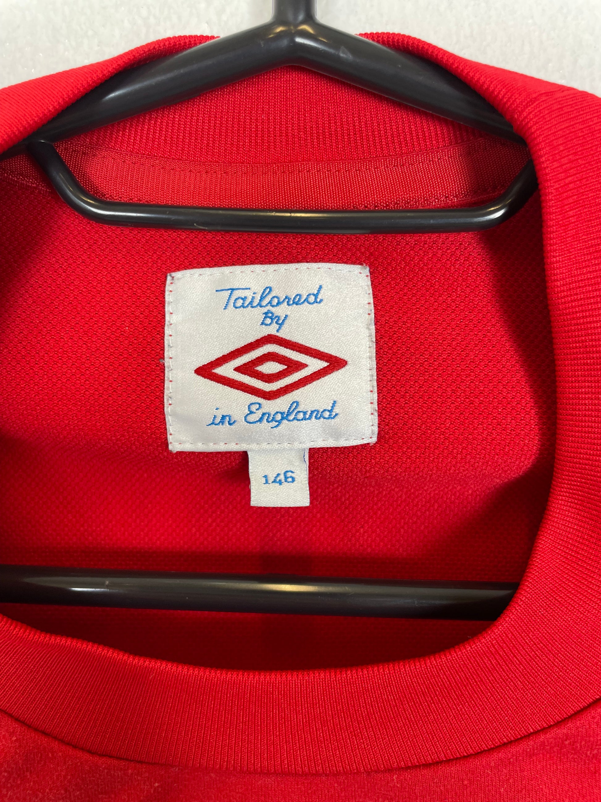 Close-up of England away shirt 2010/11 showing Three Lions badge and technical fabric details