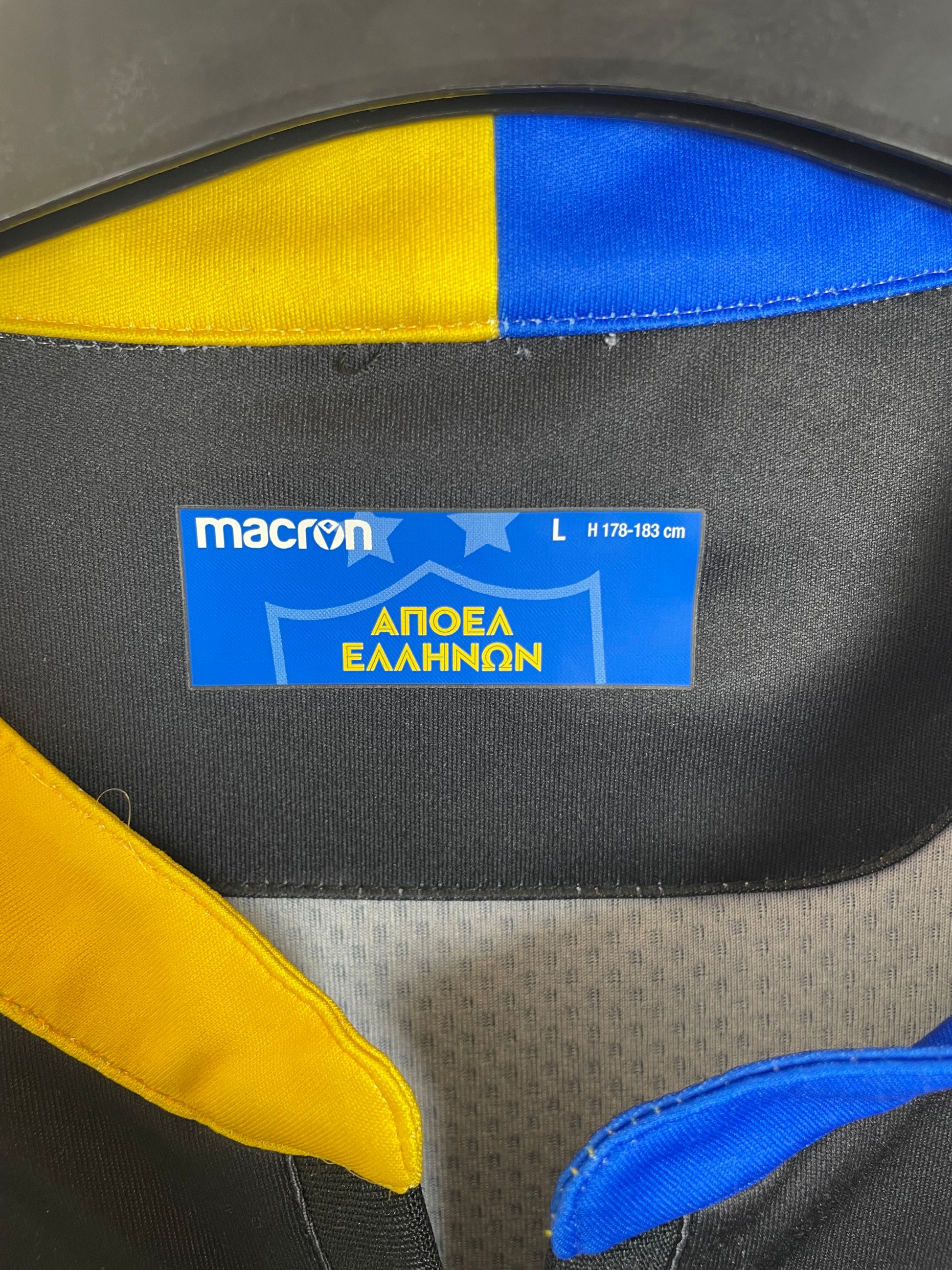 Close-up of APOEL FC club badge and Macron logo detail on 2019/21 away shirt