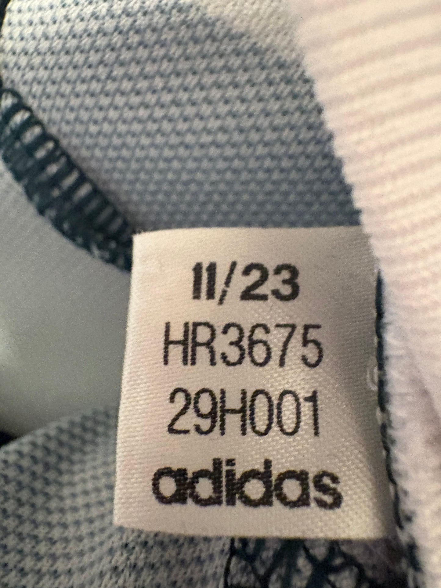 Interior care label and size L tag of authentic Adidas Manchester United Garnacho 17 away shirt