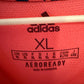 Close-up of Adidas logo and Real Madrid club crest on navy blue away shirt 20/21