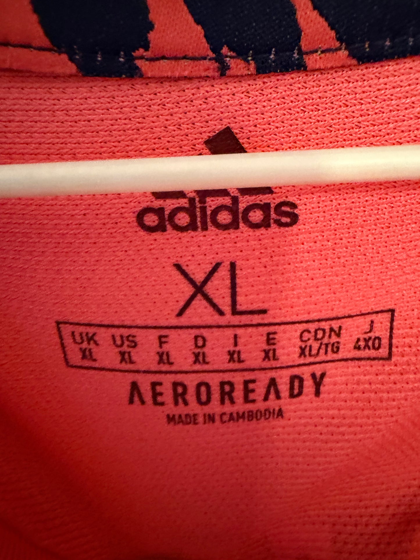 Close-up of Adidas logo and Real Madrid club crest on navy blue away shirt 20/21