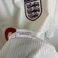 Detail view of Umbro England 99/01 home shirt showing fabric texture, stitching quality and sizing label