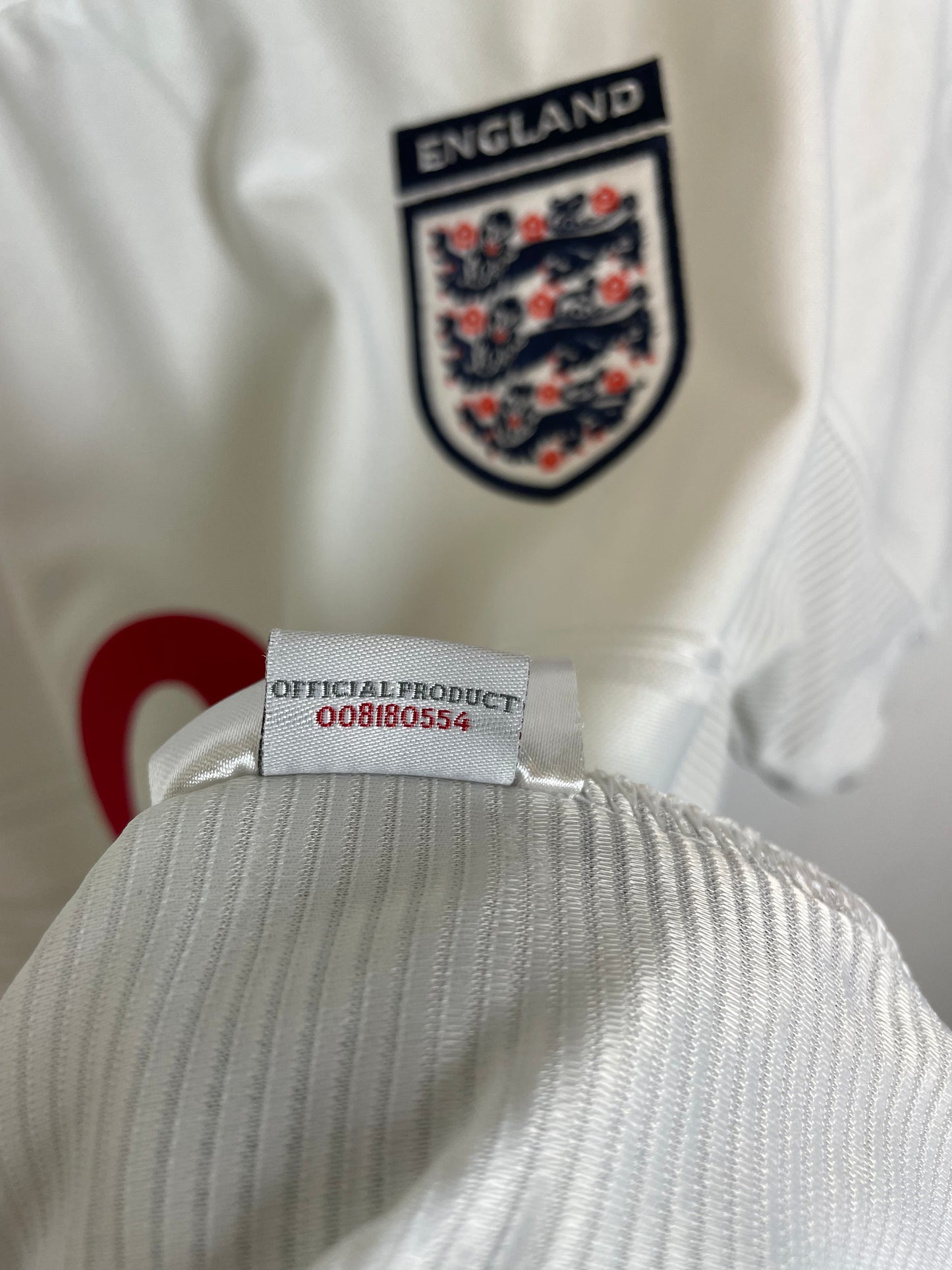 Detail view of Umbro England 99/01 home shirt showing fabric texture, stitching quality and sizing label