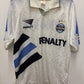White with blue and black accents, featuring 'Penalty' and 'Gremio' logos on a white background.