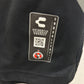 Close-up of a Club Tijuana fotballdrakt with a brand label featuring a logo and tex