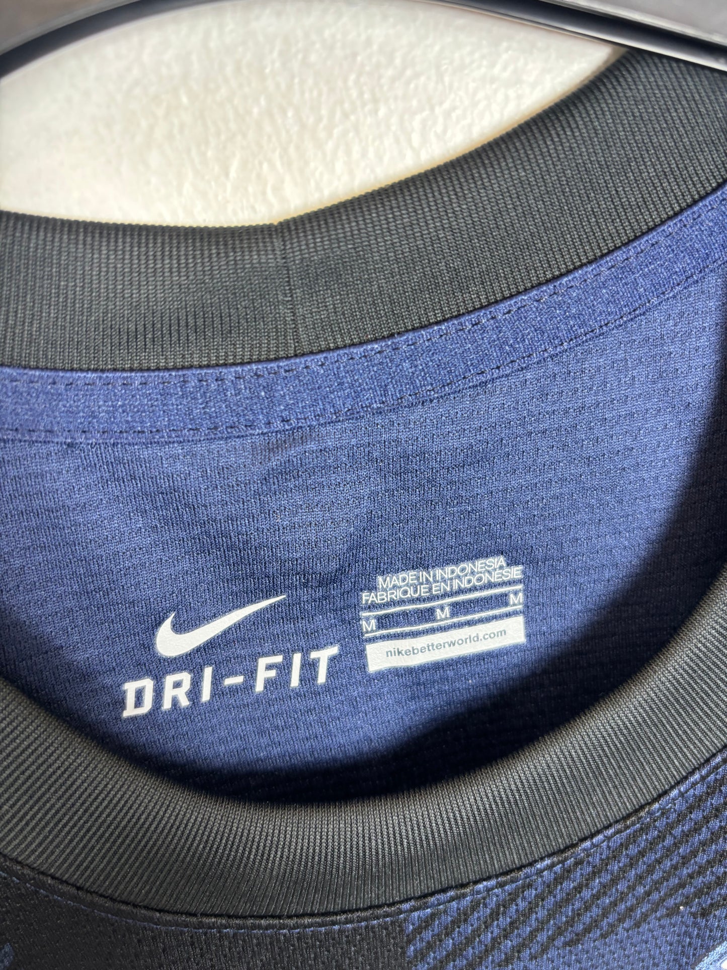 Close-up of Nike logo and Manchester United club badge on 13/14 away shirt