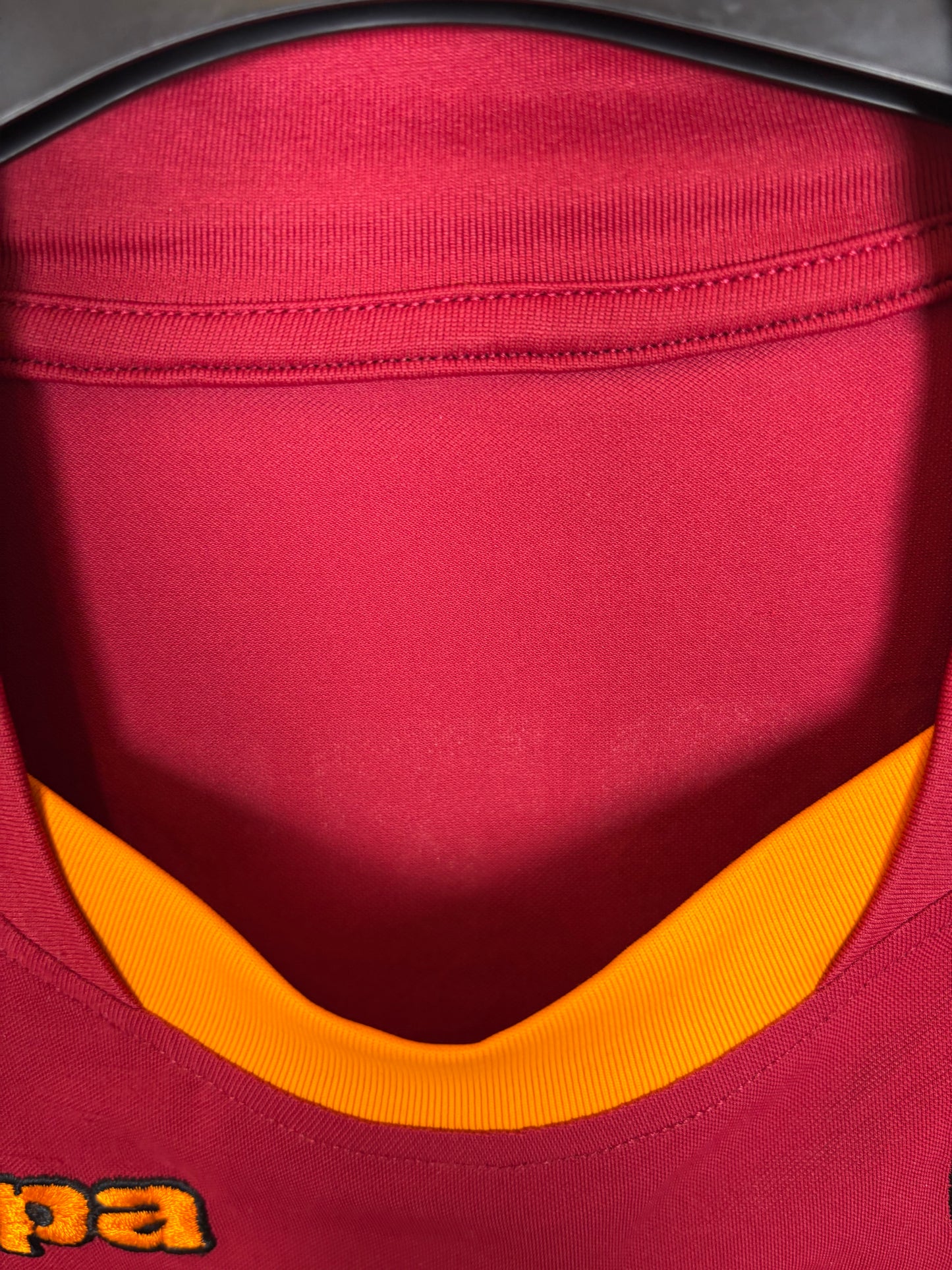 Detail view of Wind sponsor logo on the front of AS Roma 08/09 home shirt with yellow accent trim