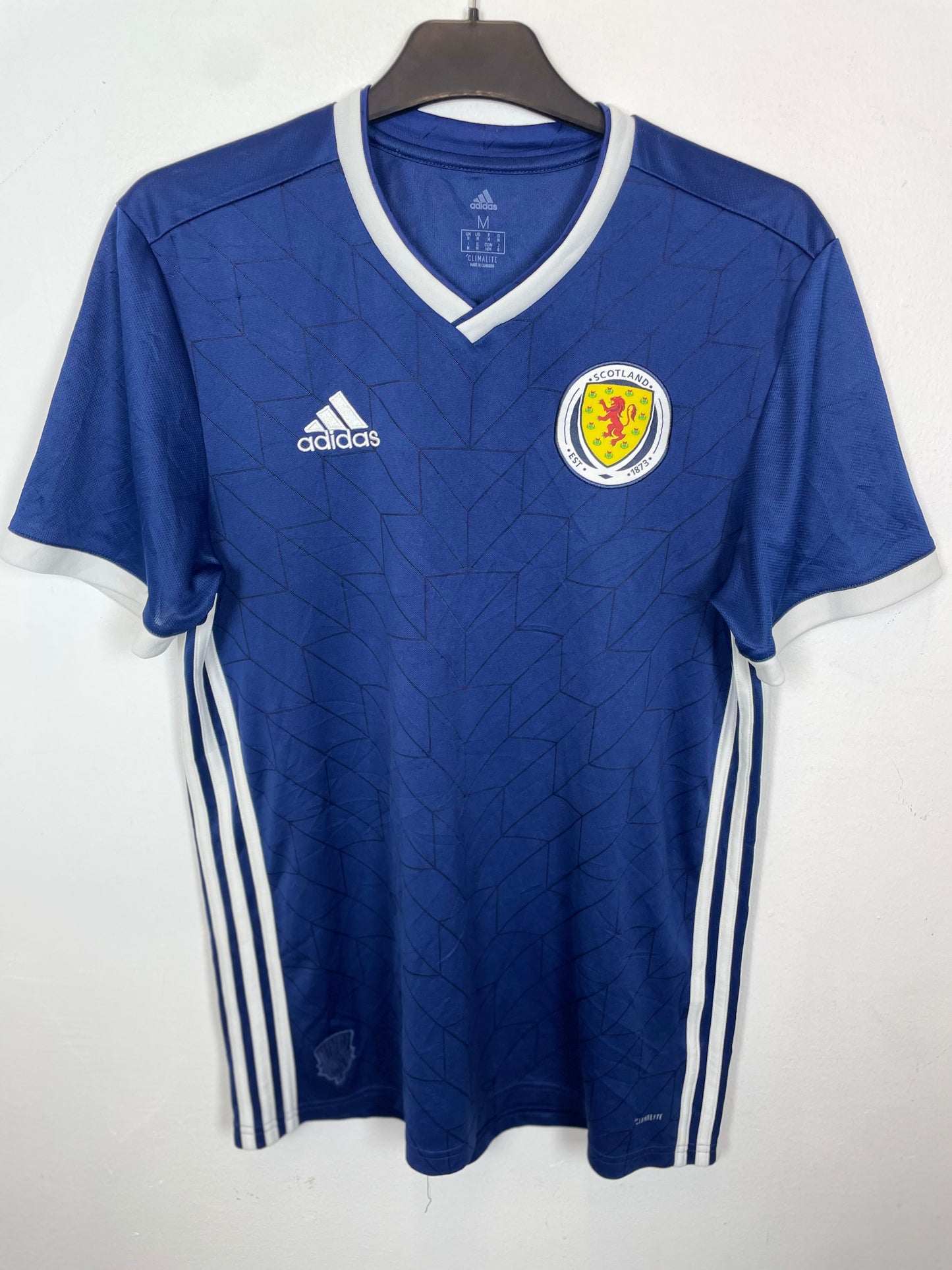Blue Scotland national team jersey with Adidas logo and Scottish emblem on a white background