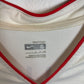 Close-up of South Korea national team badge and Nike swoosh on 2006 away shirt