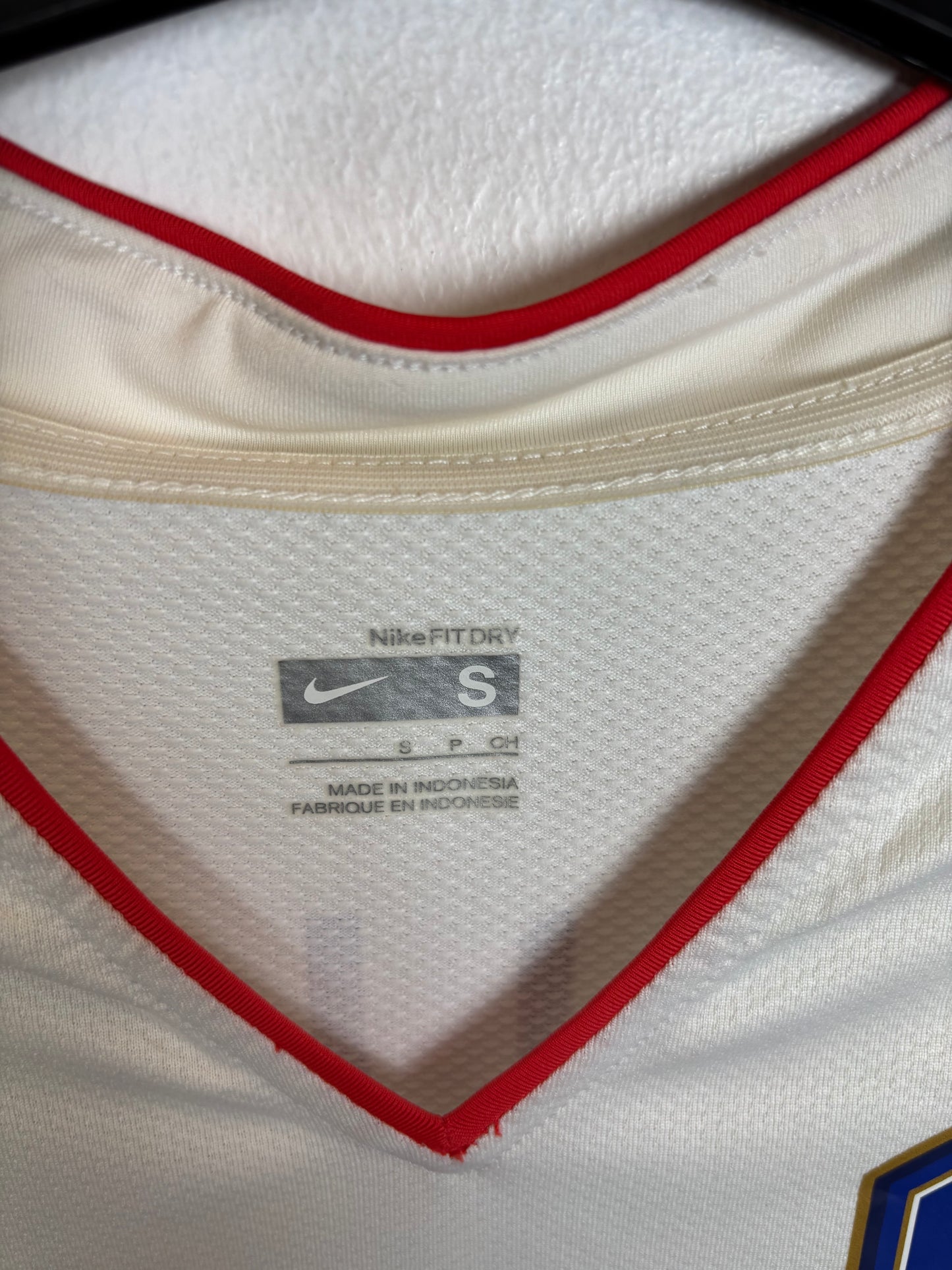 Close-up of South Korea national team badge and Nike swoosh on 2006 away shirt