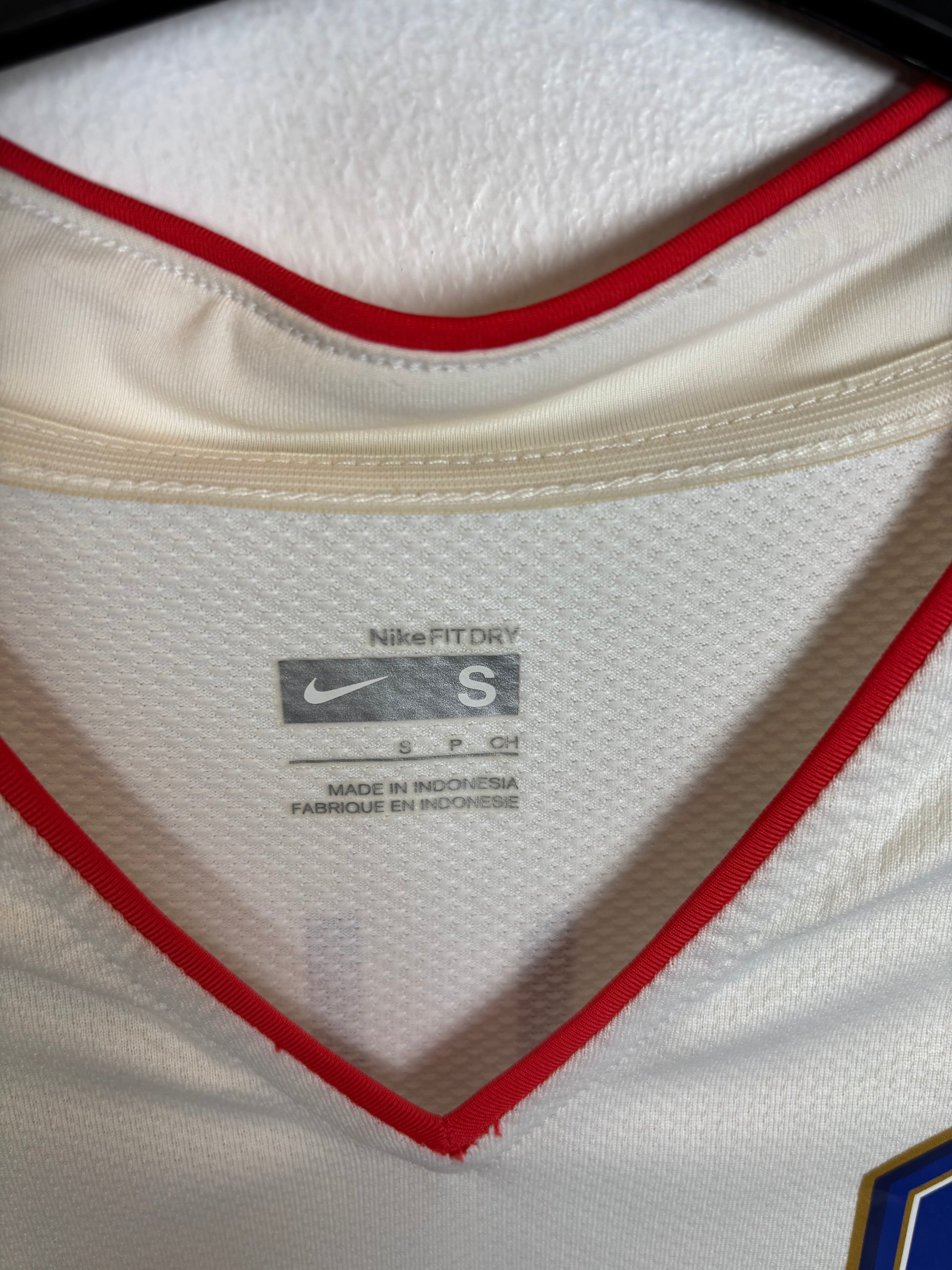 Close-up of South Korea national team badge and Nike swoosh on 2006 away shirt